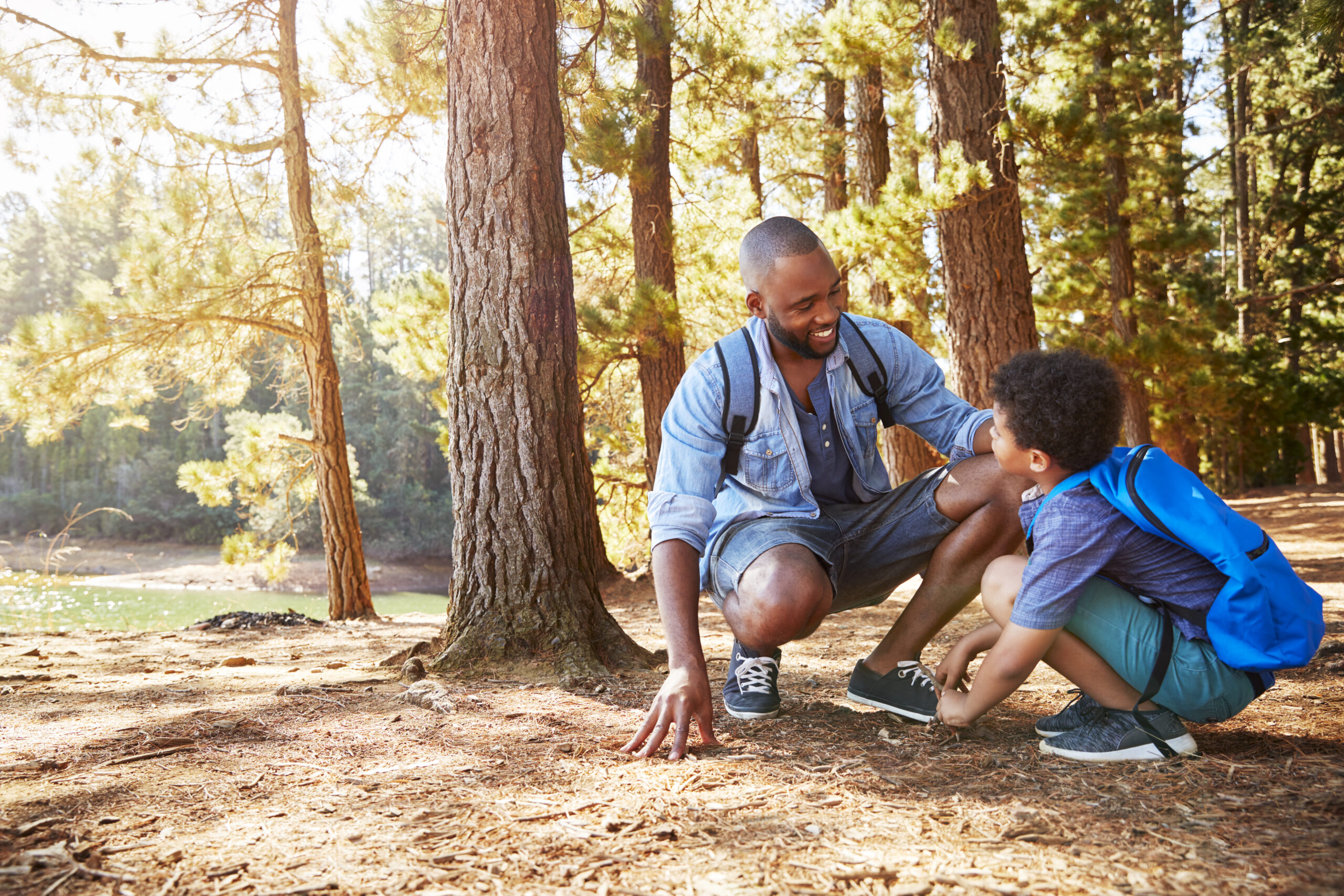 Father And Son On Hiking Adventure In Woods By Lake | Lecticon